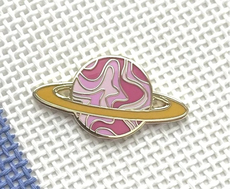 Saturnalia Logo Needle Minder